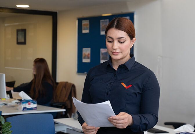 Woman holding papers in an office